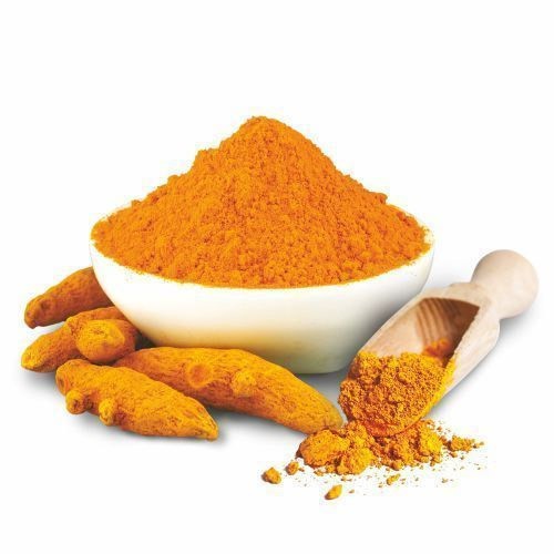 Turmeric — golden yellow powder and roots